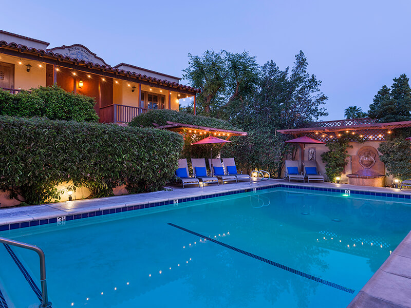 Posh hotel swimming pool at dusk in Palm Springs best Joshua Tree hotels