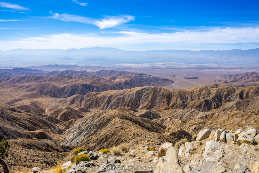 Expansive view over mojave desert in california national park with rolling mounds and blue sky
