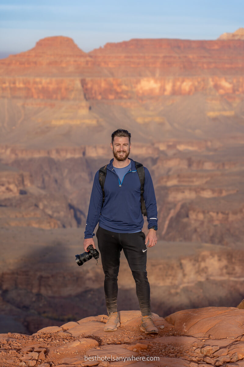 Mark Morgan from Best Hotels Anywhere hiking into the Grand Canyon with a camera on a sunny day in Arizona