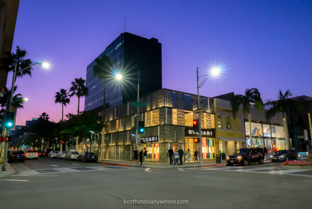 Beverly Hills Rodeo Drive shops lit up at night with colorful sky at dusk