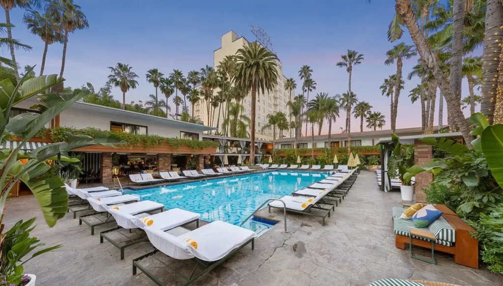 Swimming pool and decking area with loungers at dusk Hollywood Rooselvelt one of the best hotels in Los Angeles for first time visitors