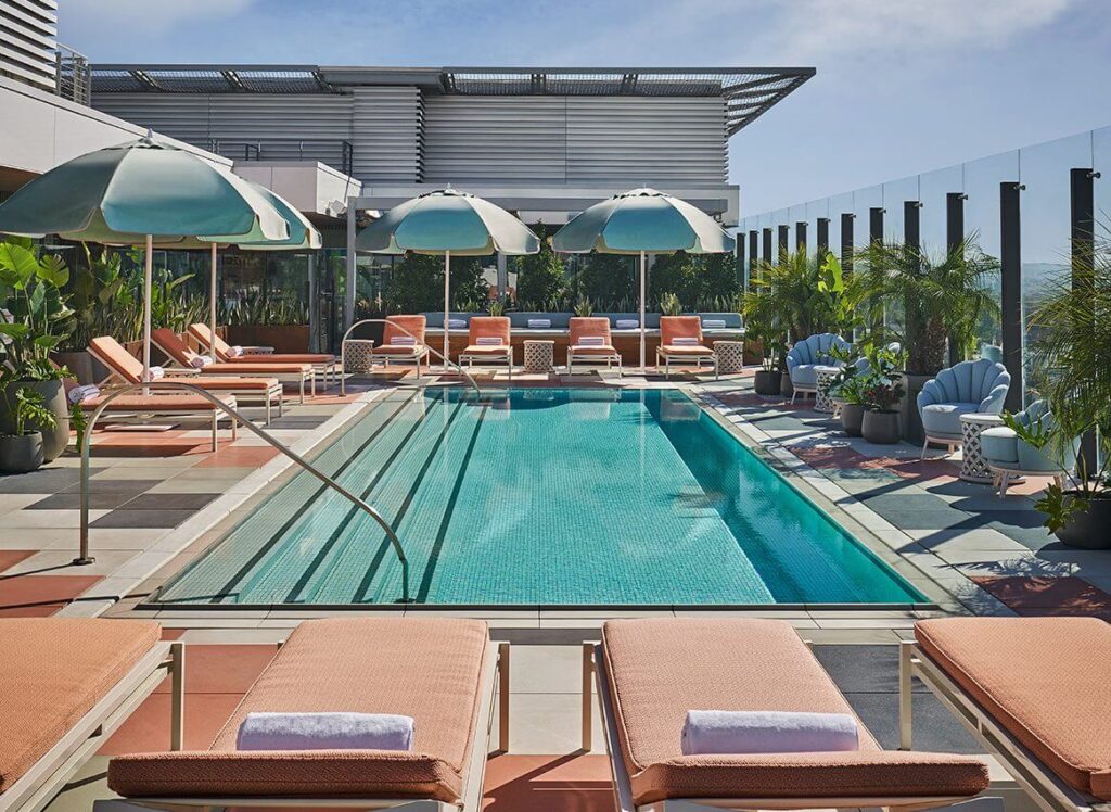 Sun loungers and swimming pool with umbrellas on a sunny day in California