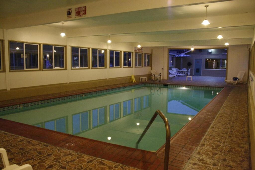 Indoor swimming pool with low roof and lights