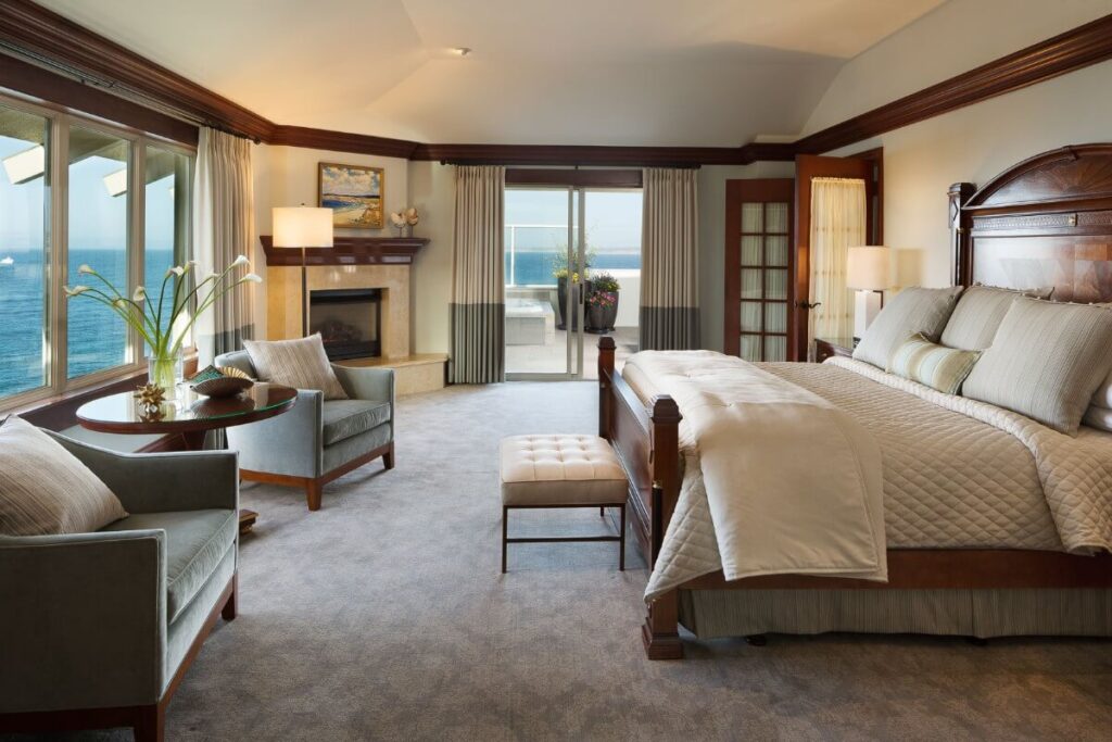 Beautiful guest room high quality furniture leading to windows overlooking the bay best Monterey CA hotels