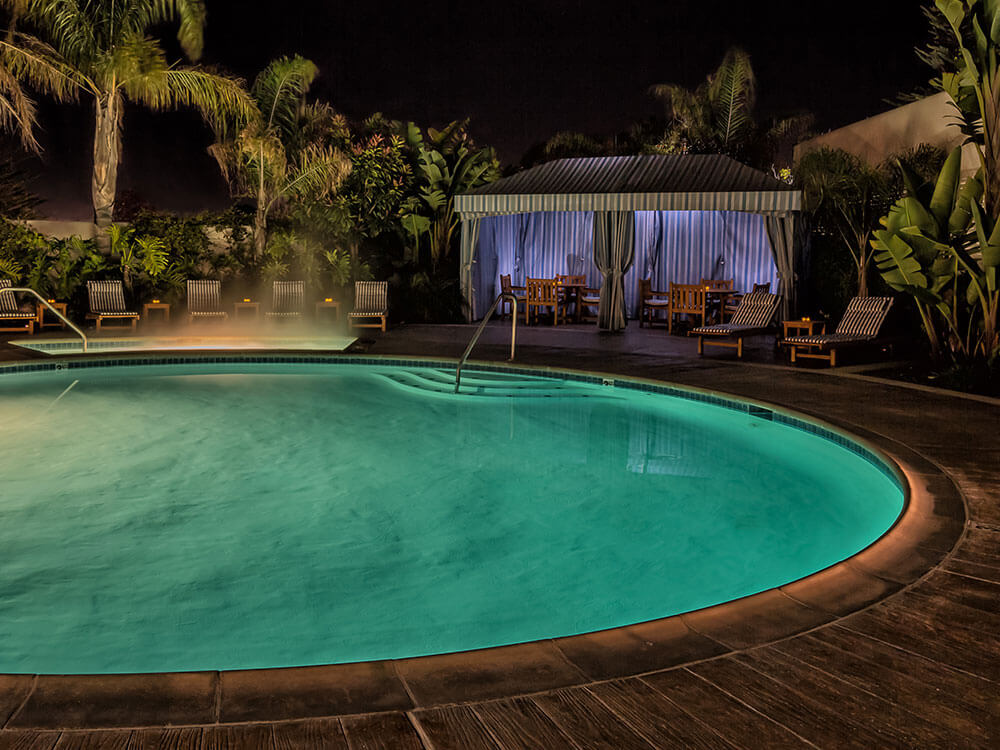 Outdoor swimming pool turquoise colored against the dark night sky