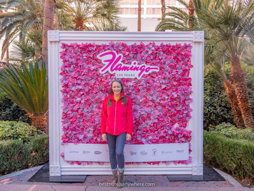 Kristen from Best Hotels Anywhere at the Flamingo hotel in Las Vegas posing for photo with pink board and sign