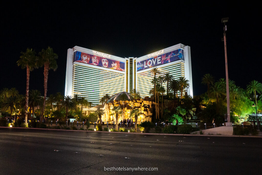 The Mirage hotel lit up at night with Beatles one sign on the Las Vegas strip