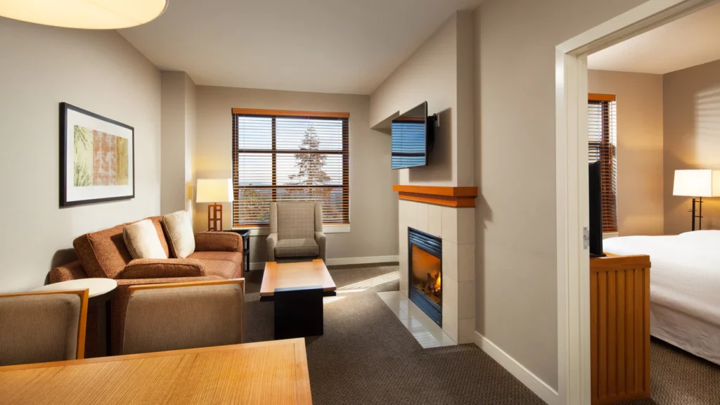 Guest room at the Westin Monache resort hotel in Mammoth Lakes CA with bed sofa fireplace and tv