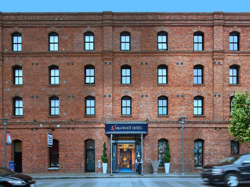 Argonaut Hotel in San Francisco brick building facade 4 story tall and wide structure with entrance and cars