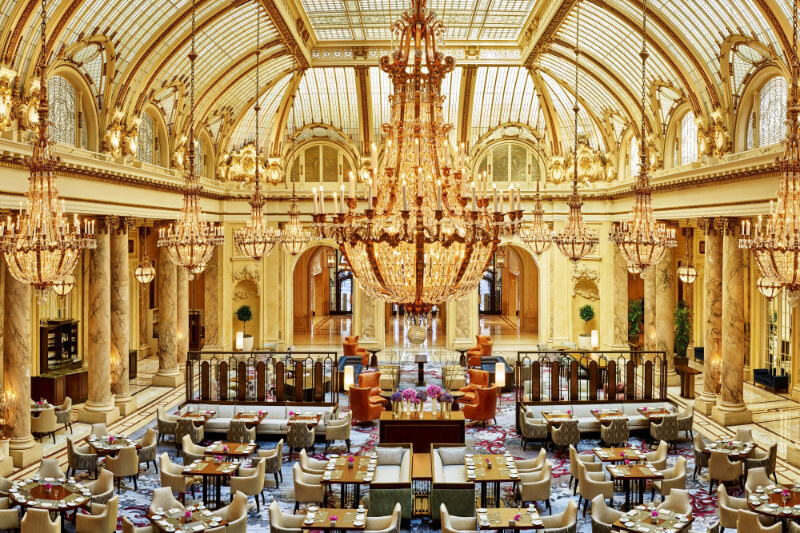 Lavish and striking golden dining hall with chandelier inside the Palace Hotel in San Francisco California