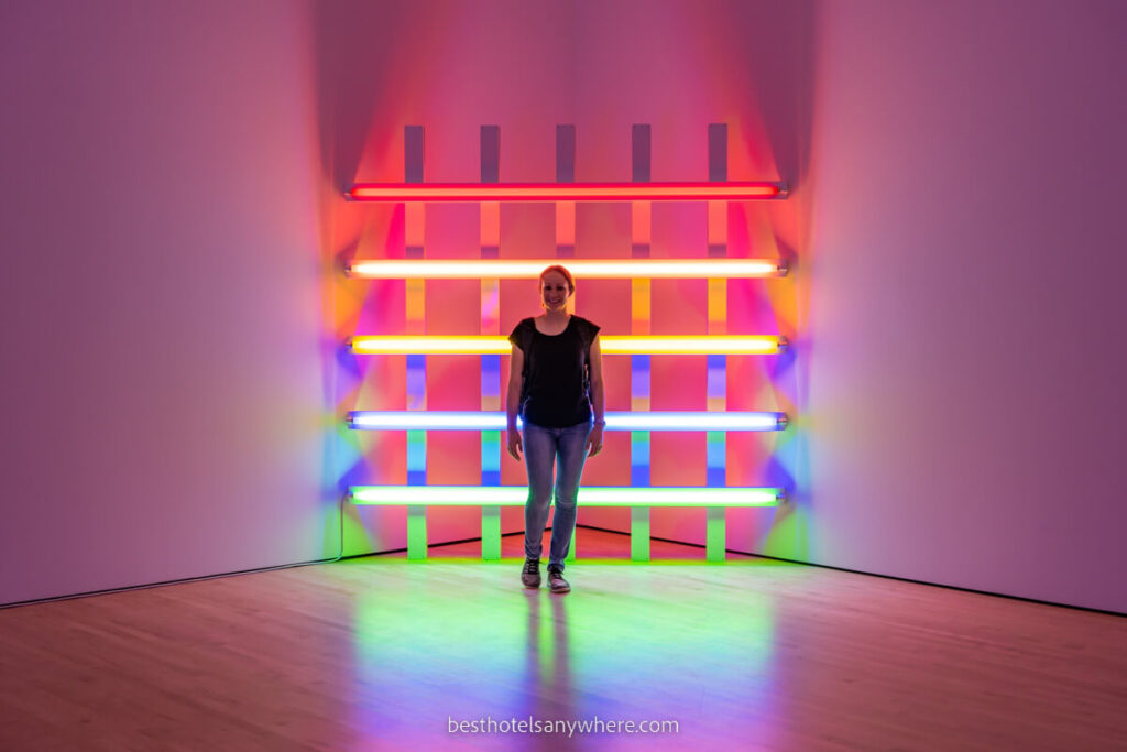 Woman stood in front of colorful hashtag shaped art installation in SF MoMA