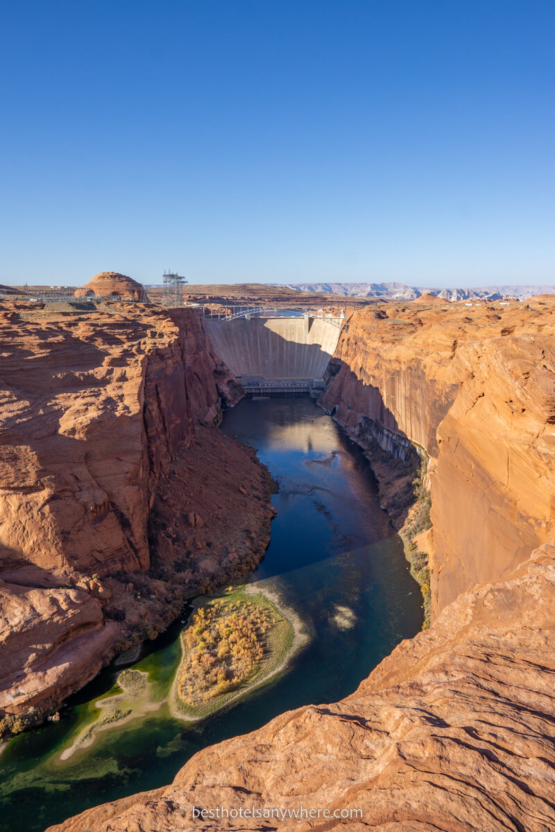 Glen Canyon Dam from a viewpoint looking down the Colorado River on a bright sunny day