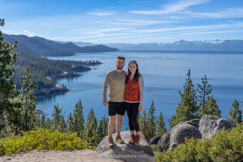 Photo of couple at the summit of a hike with Lake Tahoe in the background