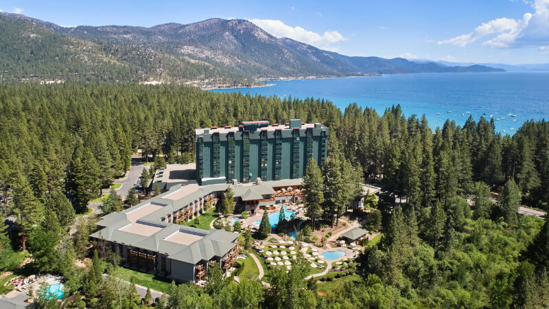 Hyatt Regency Resort hotel in North Lake Tahoe drone photo from high up with hotel trees and the lake