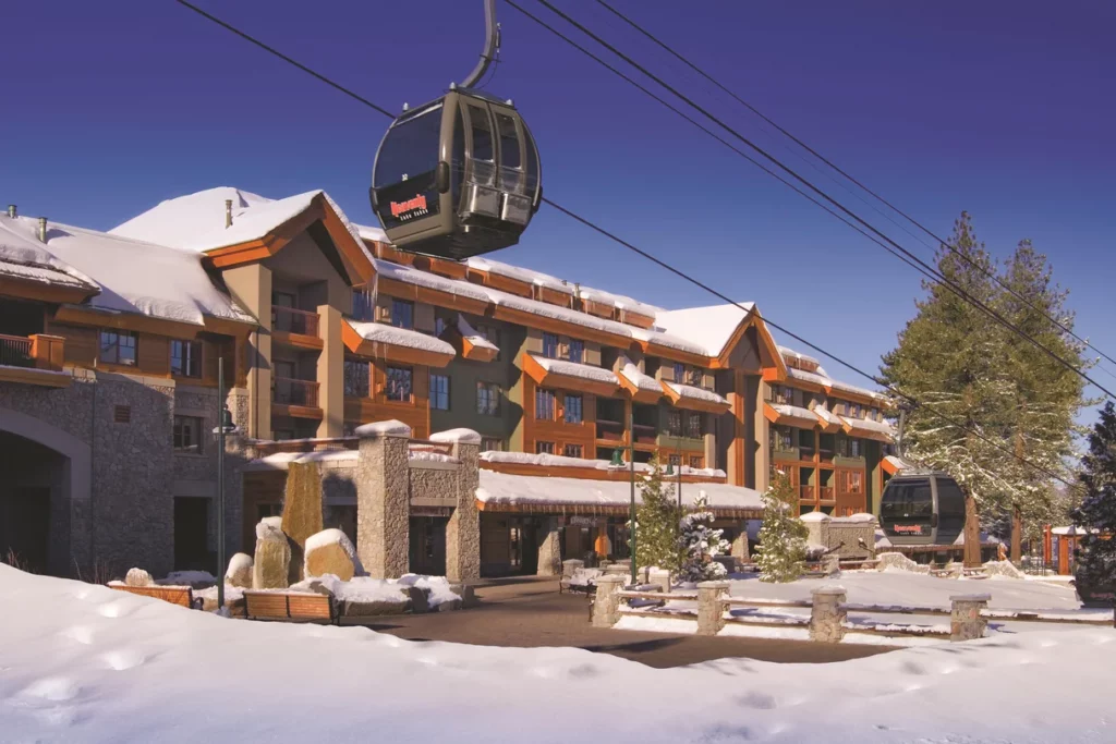 Huge wooden hotel structure covered in snow with cable car in South Lake Tahoe