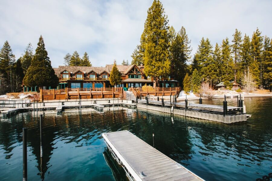 Pier in Lake Tahoe leading to a hotel on the shore and trees behind
