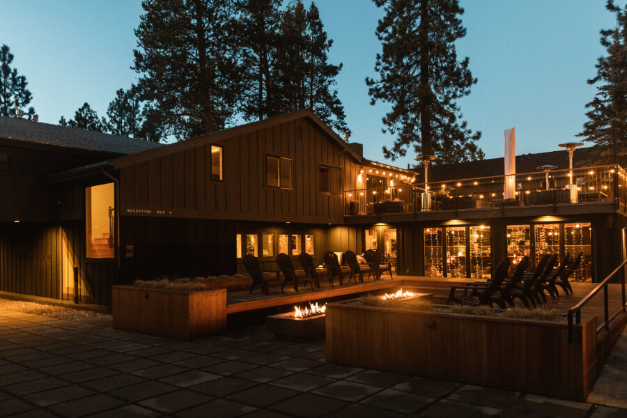 South Lake Tahoe hotel at night with soft yellow lighting and fire pits