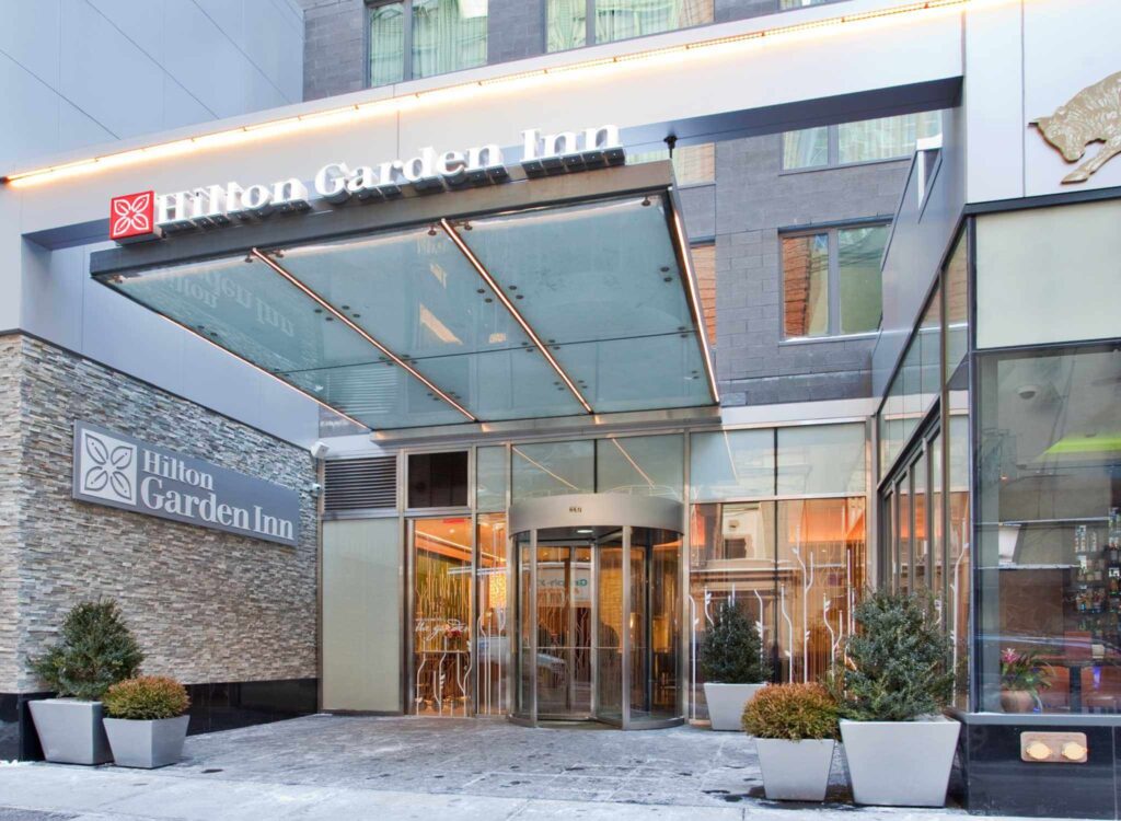 Exterior photo of the Hilton Garden Inn in New York entrance and lobby