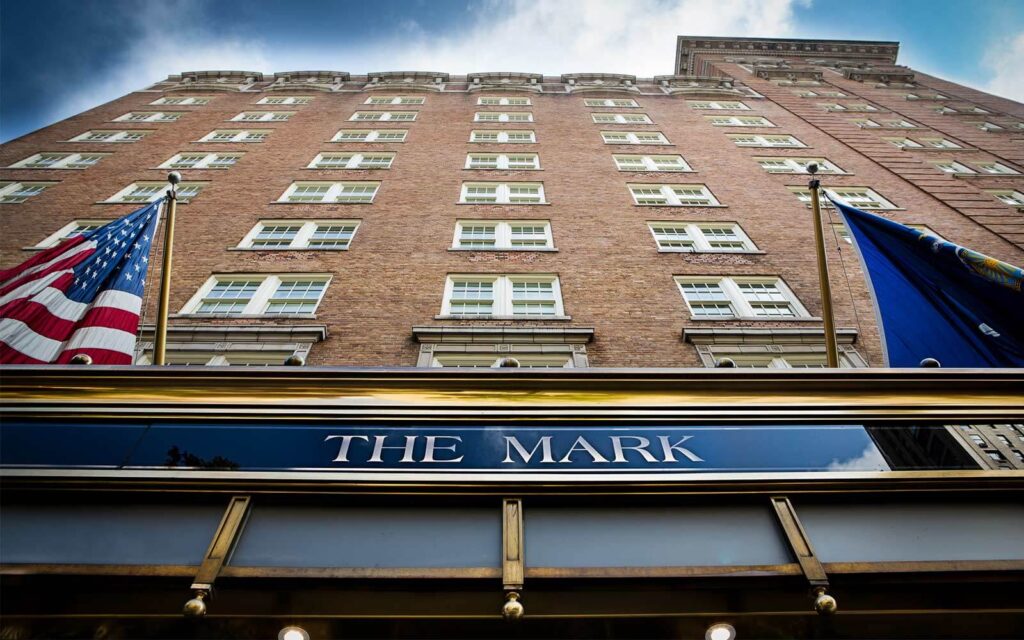 Exterior photo of The Mark hotel in Upper East Side NYC looking directly up at the brick building facade from below