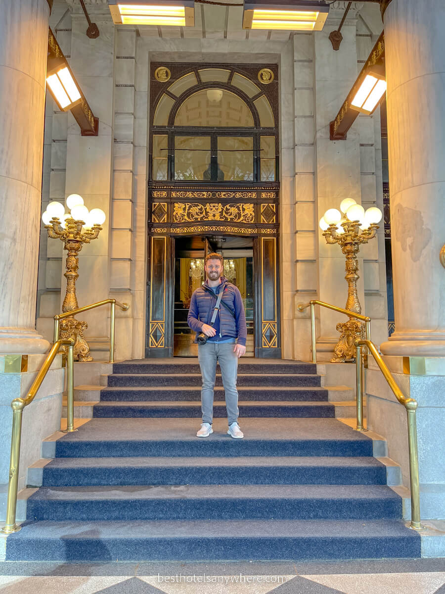 Tourist on the steps leading up to Plaza Hotel in New York City
