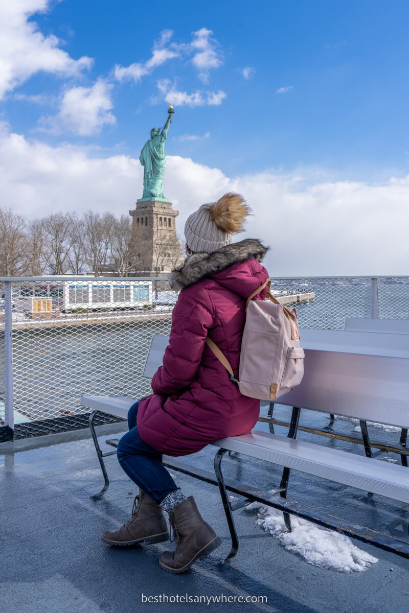 Person on a bench on the Statue of Liberty Ferry