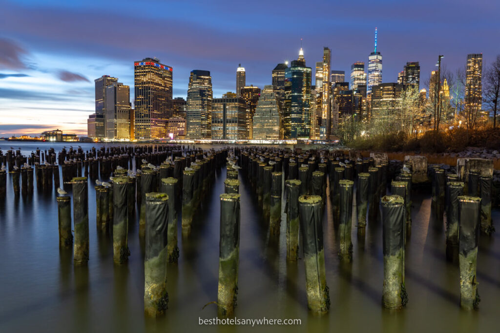 Lower Manhattan skyline lit up at night from Old Pier 1 in Brooklyn