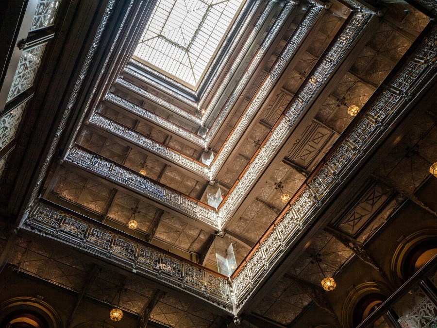 9 story atrium and glass pyramid roof at The Beekman Hotel in New York
