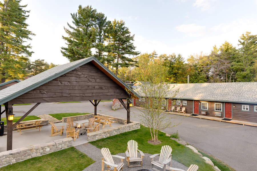 Exterior grounds photo of a lodge with seating area undercover and fire pits