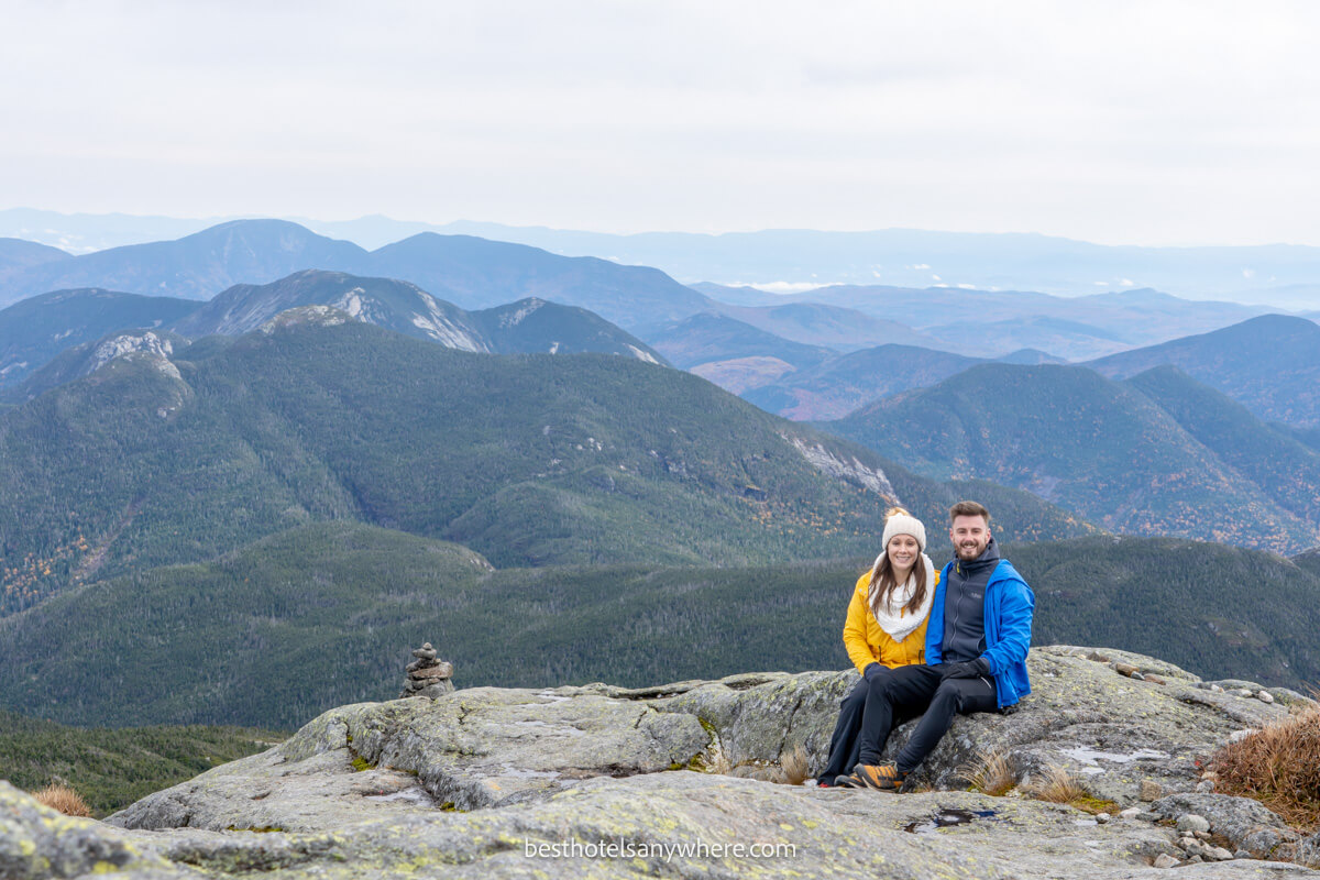 Mark and Kristen Morgan from Best Hotels Anywhere sitting at the summit of Mt Marcy hike near Lake Placid NY