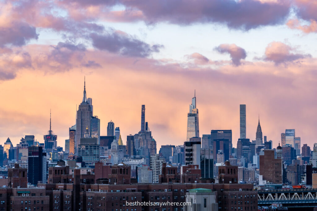 Manhattan skyline at sunset with sky lighting up orange and pink