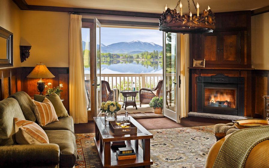 Inside guest suite with fireplace and lake views from upscale furnishings