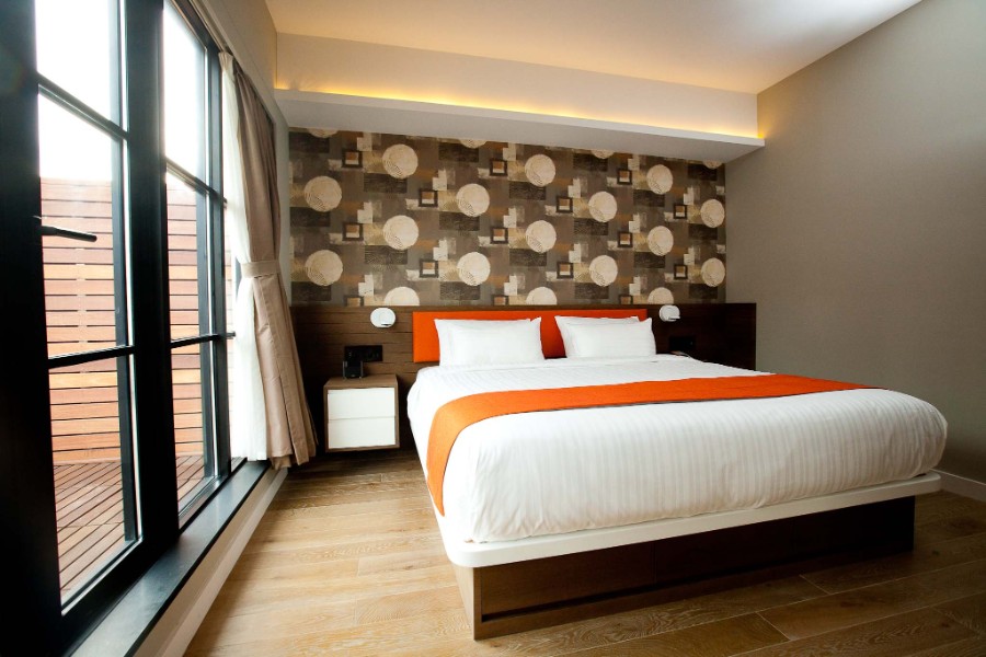 Guest bedroom with queen bed and huge floor to ceiling windows