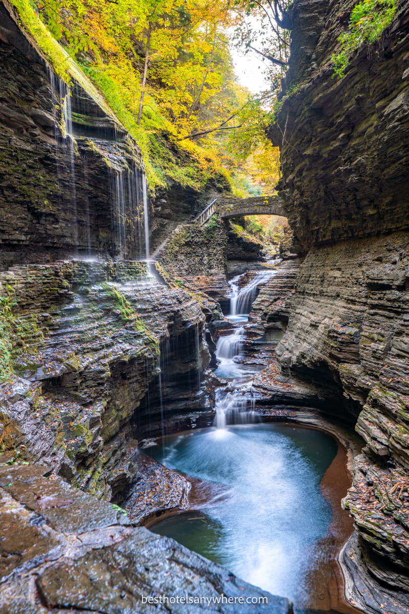 Rainbow Falls in Watkins Glen series of waterfalls through a narrow gorge and colorful leaves in trees above