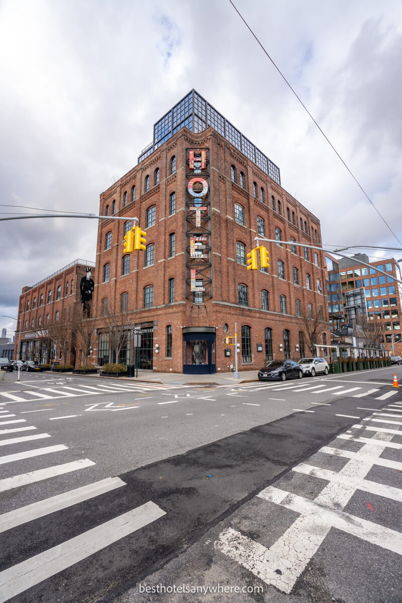 Exterior photo of a brick building in Brooklyn New York with pedestrian crossings and thick clouds in the sky