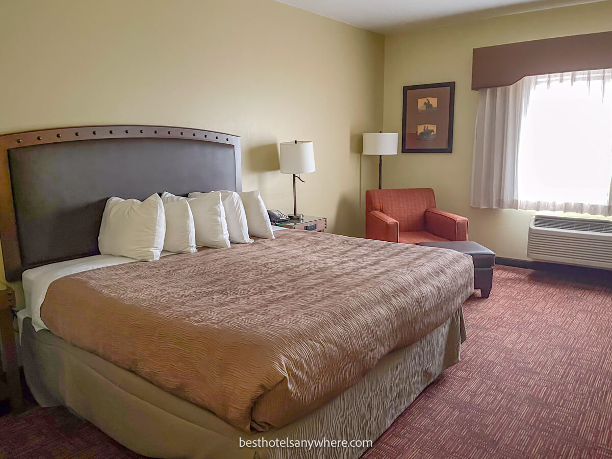 Guest room at best western plus hotel in Williams AZ large bed with armchair and bright light