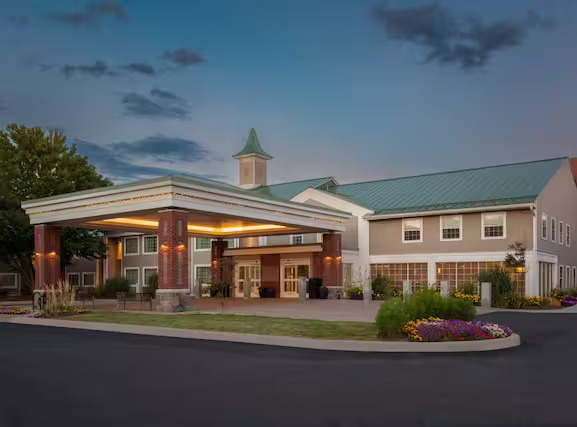 Exterior photo of a hotel entrance lit up at dusk