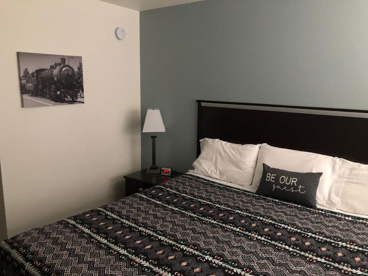 Inside a guest bedroom at a small motel bed with patterned duvet cover