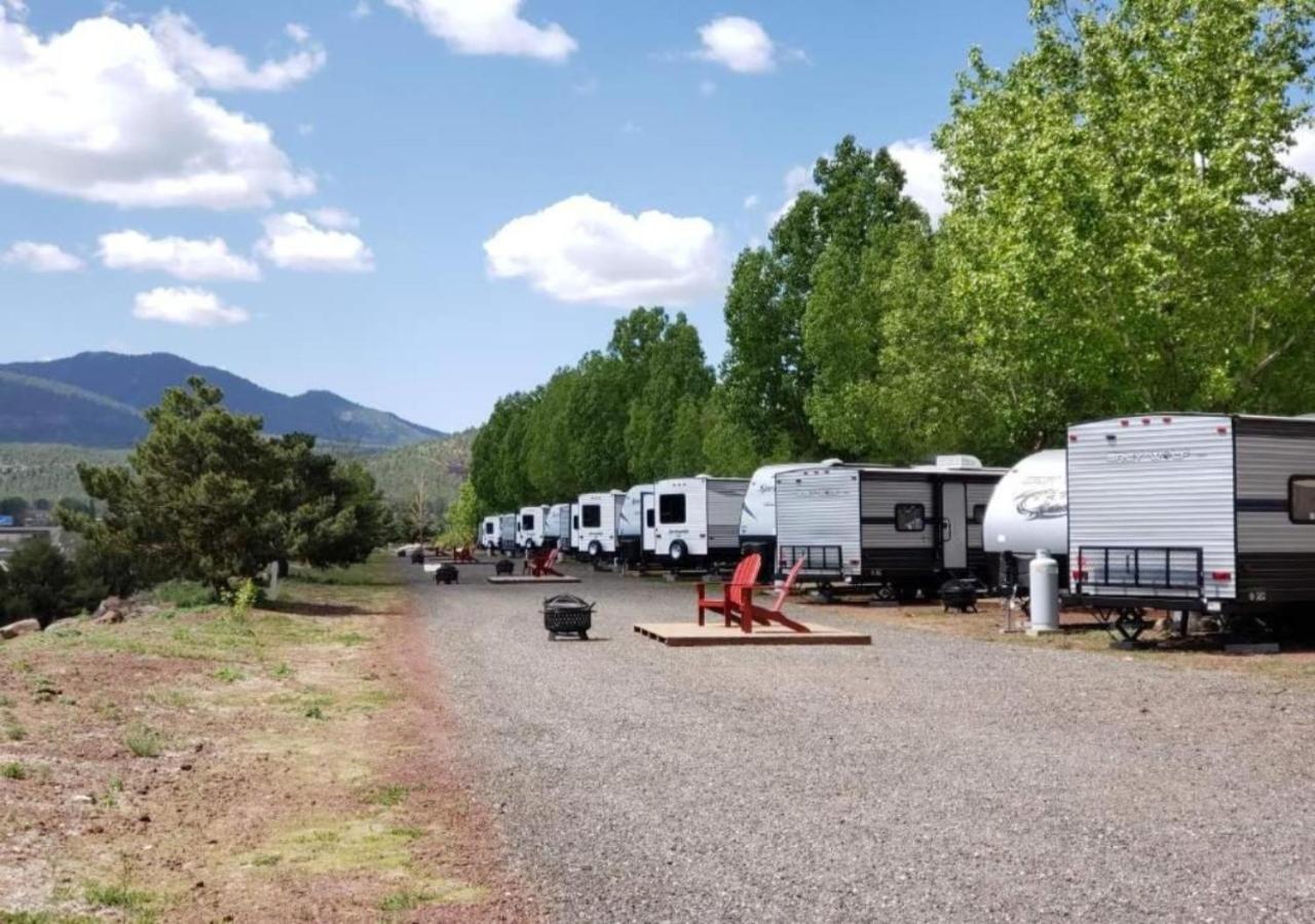 RV's parked in a line on a gravel road with open views on a clear day