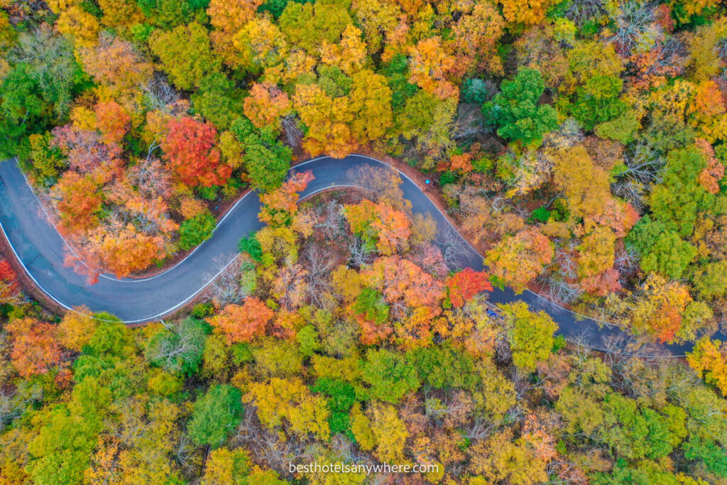 Smugglers Notch in Stowe winding road surrounded by colorful leaves in autumn