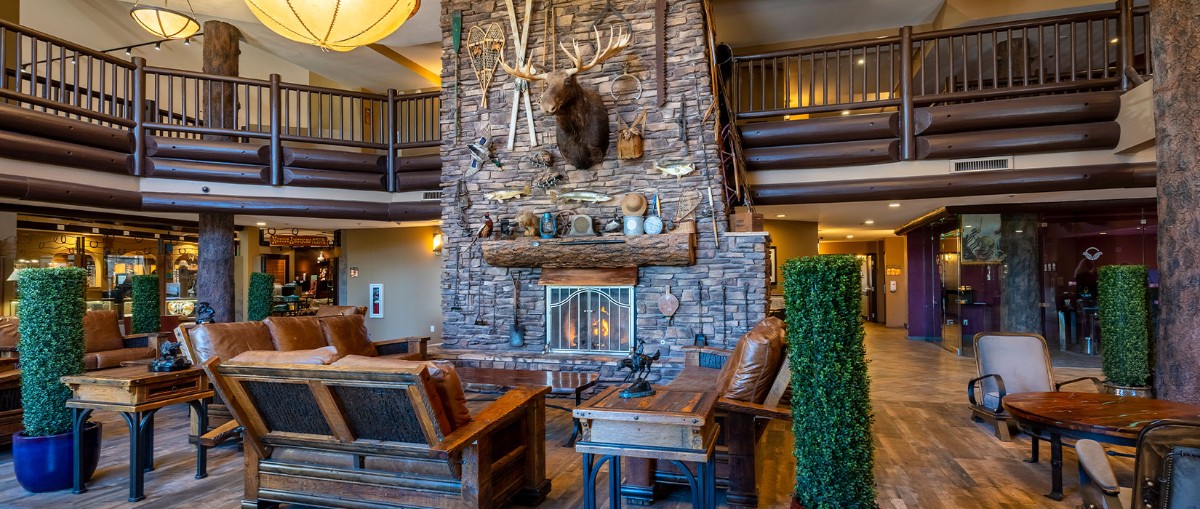 Inside the Grand Hotel at the Grand Canyon lobby with chairs and tables near a fireplace