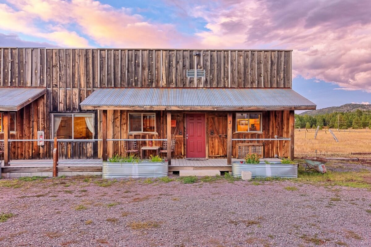 Exterior photo of a wild west themed lodging in Williams AZ with colorful clouds in the sky