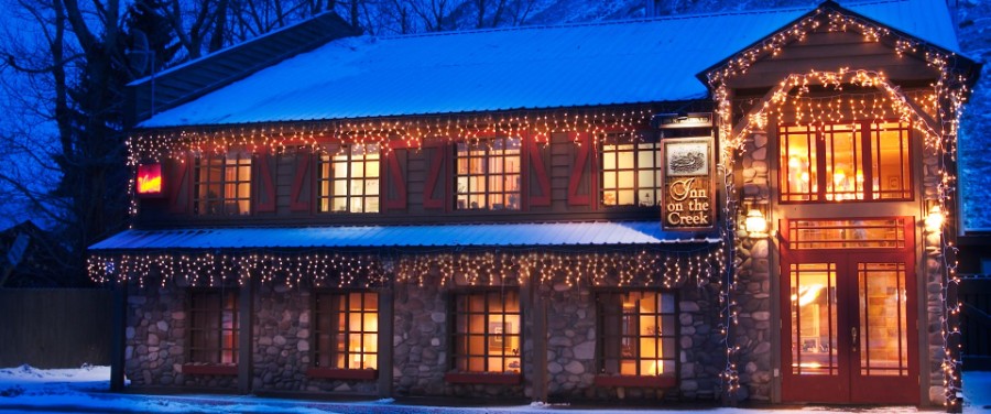 Exterior photo of a Jackson Wyoming hotel lit up at night in the snow