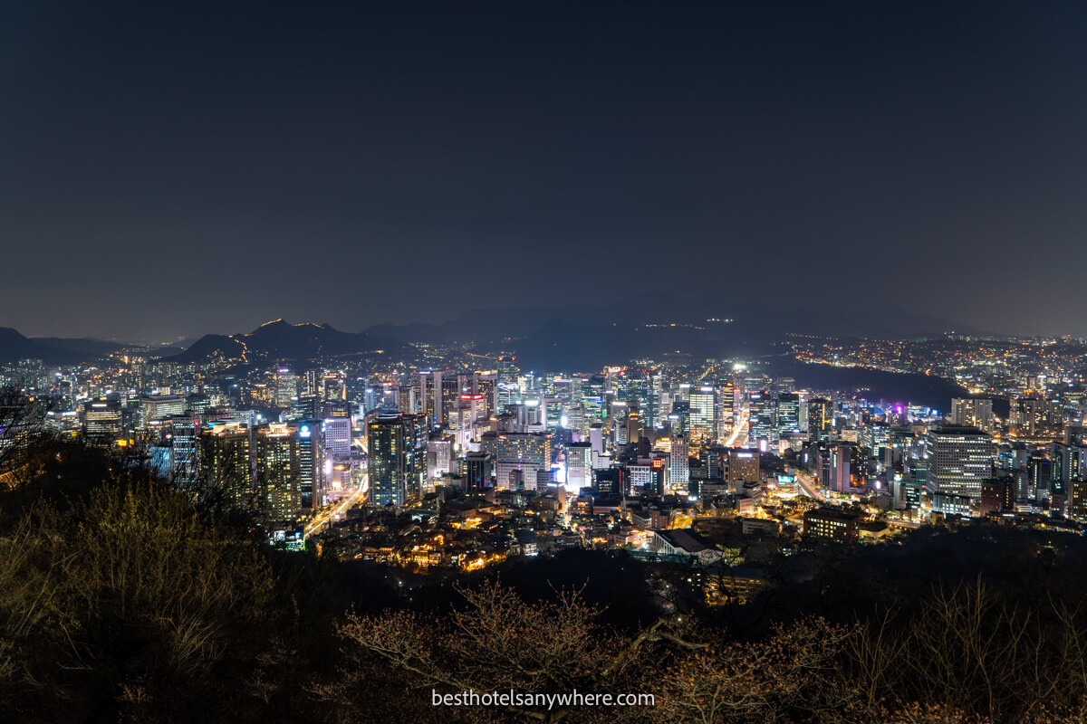 Photo of Myeongdong neighborhood in Seoul at night with buildings lit up from a distance