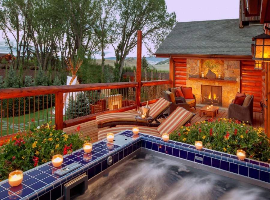 Plush outdoor jacuzzi with candles overlooking a view in Wyoming