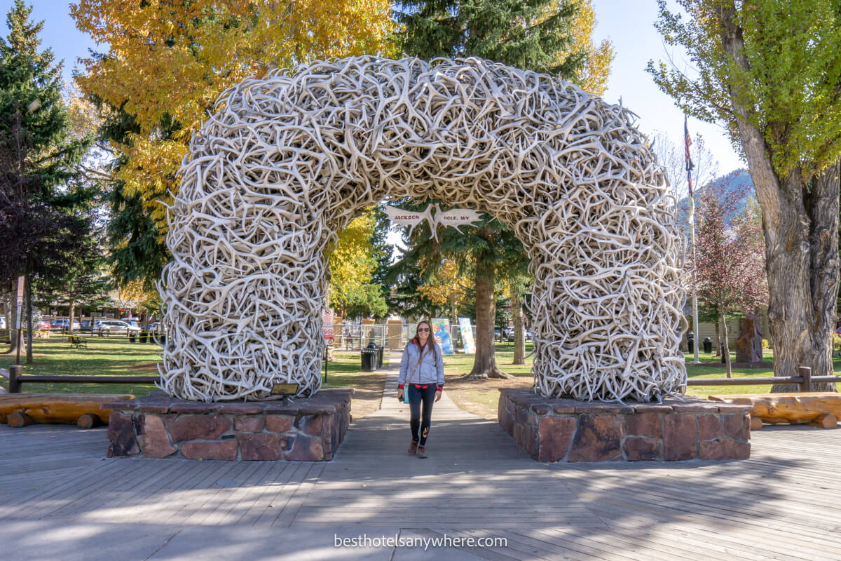 Tourist standing underneath the famous Jackson Wyoming antler arch