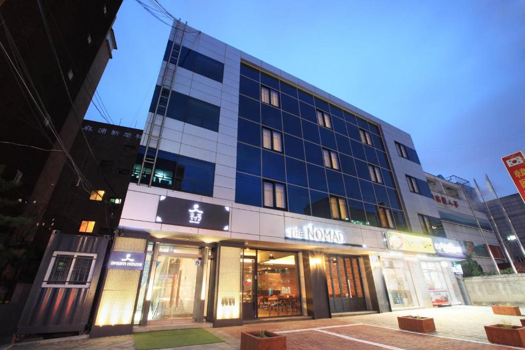 Exterior photo of a hotel lit up at night in Hongdae Seoul