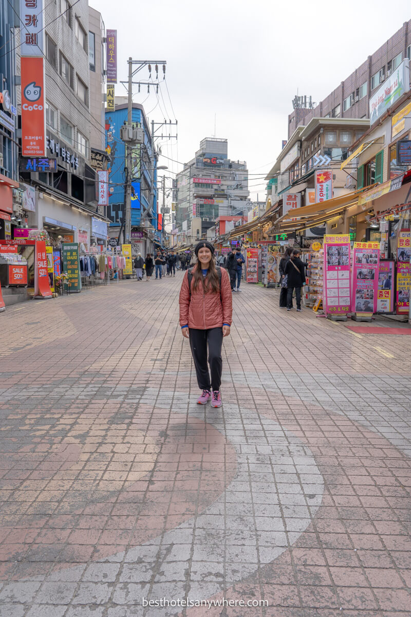 Tourist stood in the middle of Hongdae shopping street on a cloudy day in Seoul