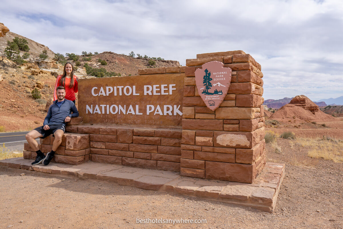Couple at the Capitol Reef National Park entrance sign