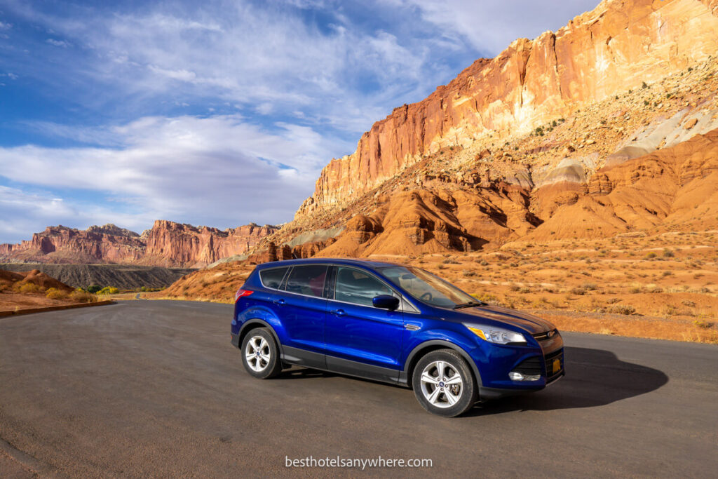 Capitol Reef scenic drive with a blue ford escape on the road