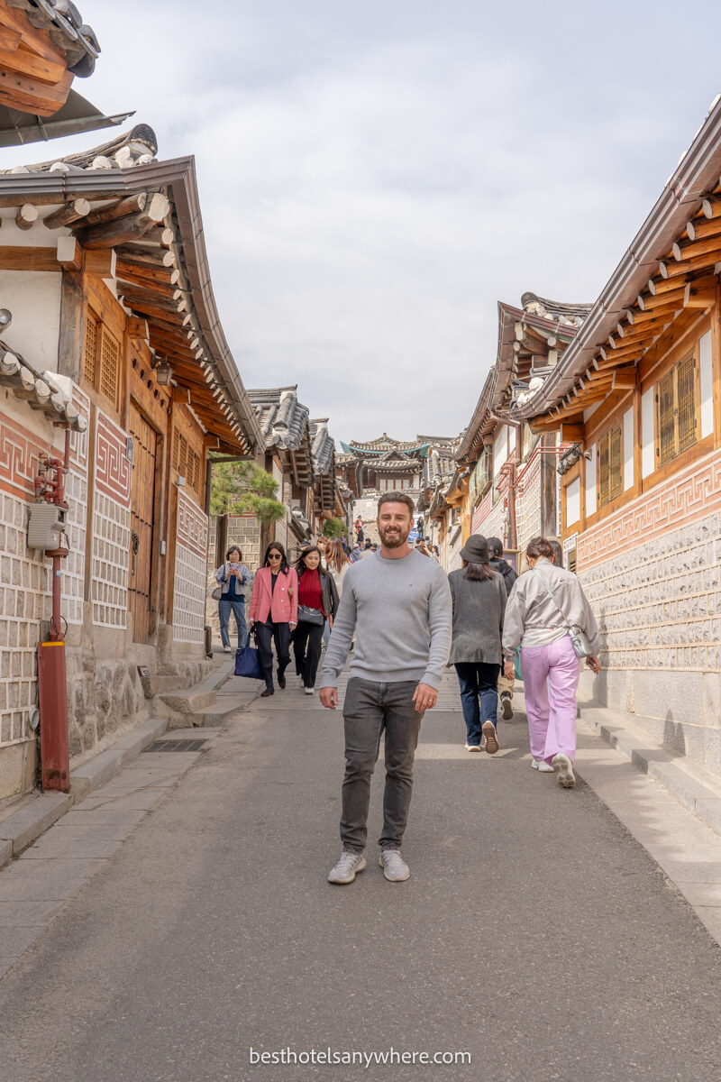 Tourist walking down a narrow old street in Seoul
